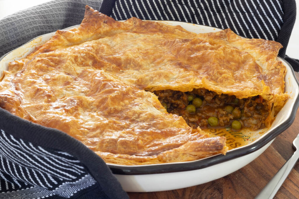 Curried Beef Pie with a slice removed.