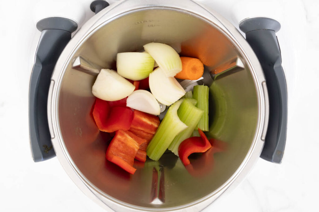 Step 1 of Curried Beef Pie process in a Thermomix, chopping the vegetables.
