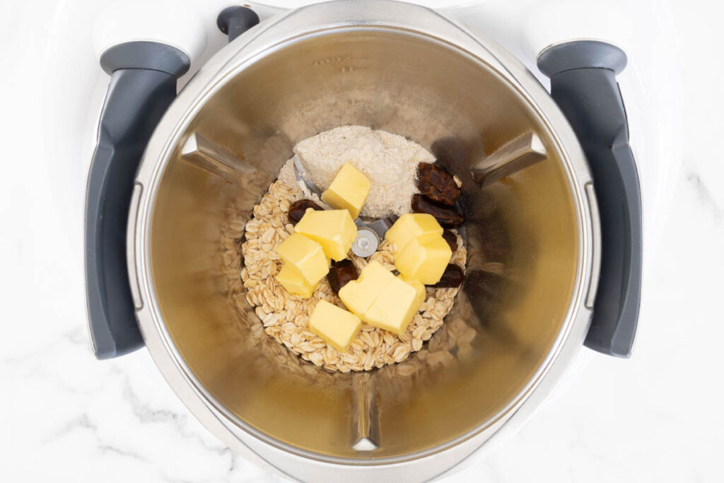 Step 5 of Strawberry and Apple Crumble process, making the crumble topping in a food processor.